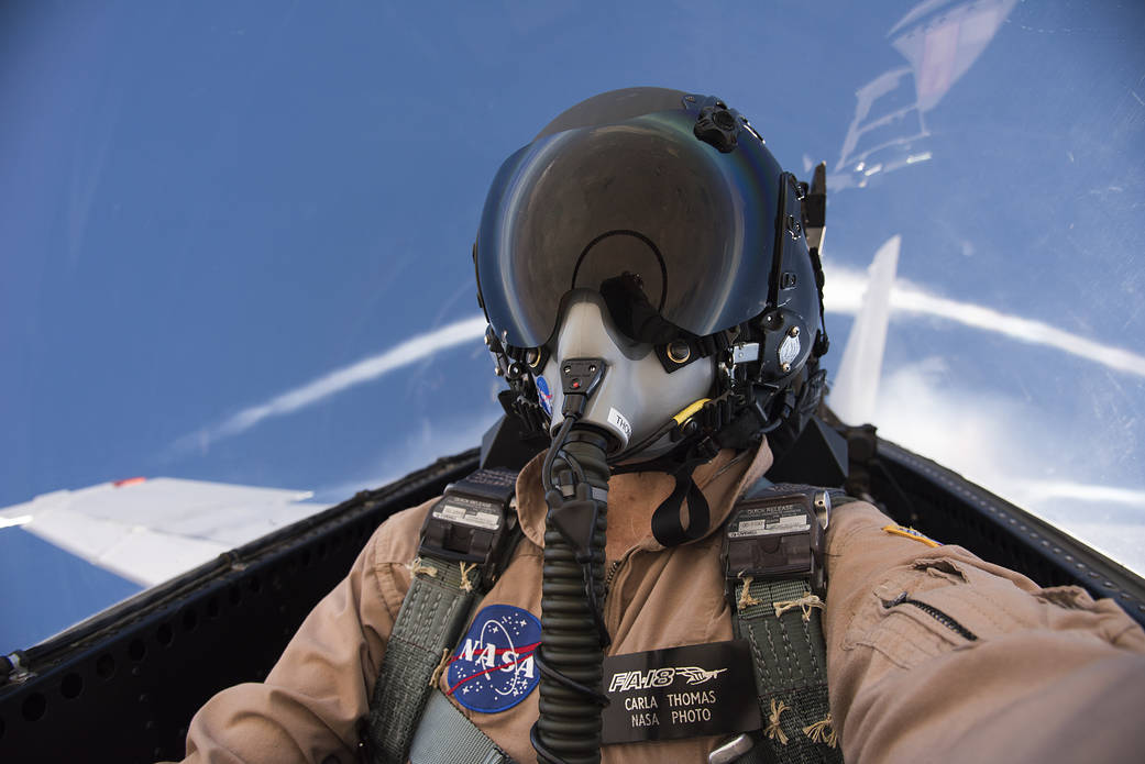 A pilot flying an airplane from their pressurized cabin.