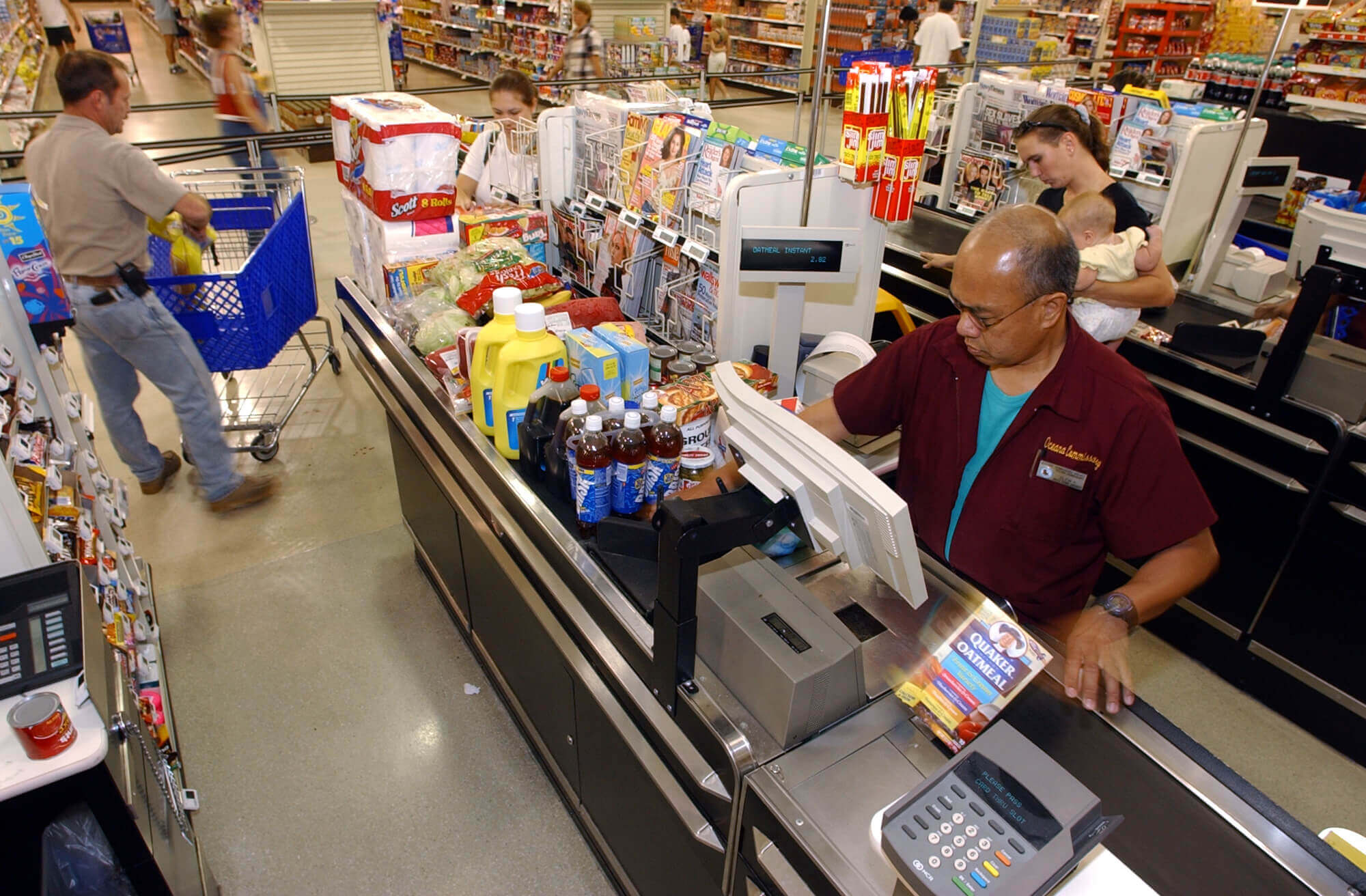 Grocery store cashier scanning groceries