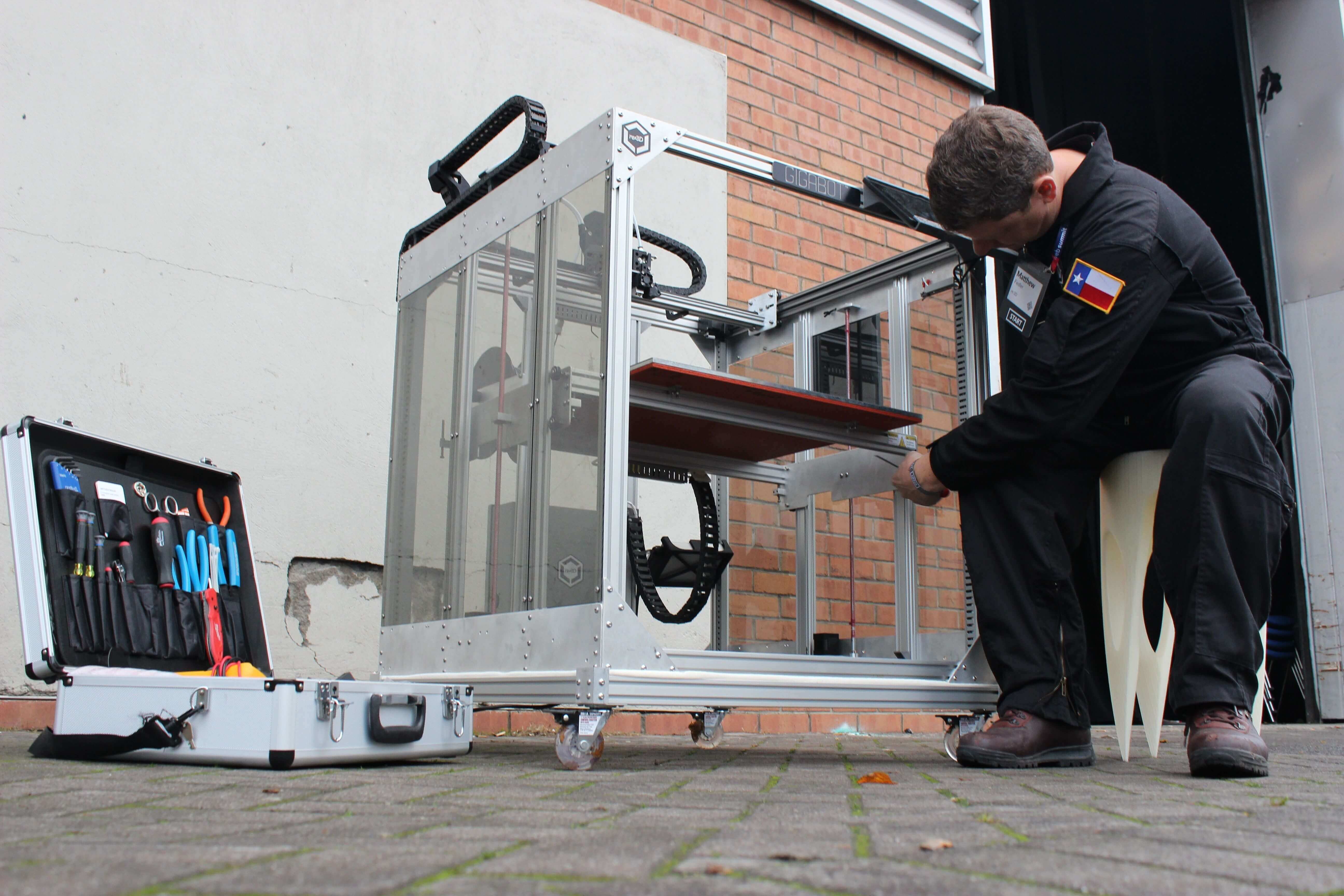 Man assembling a large-scale 3D printer