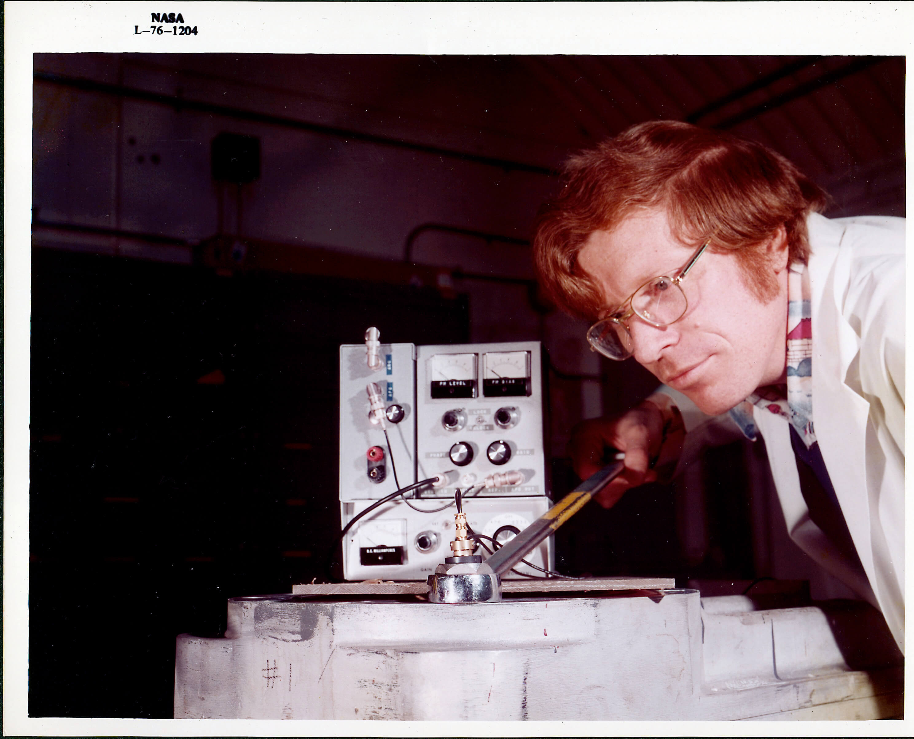 NASA engineer using an ultrasonic device to measure bolt elongation