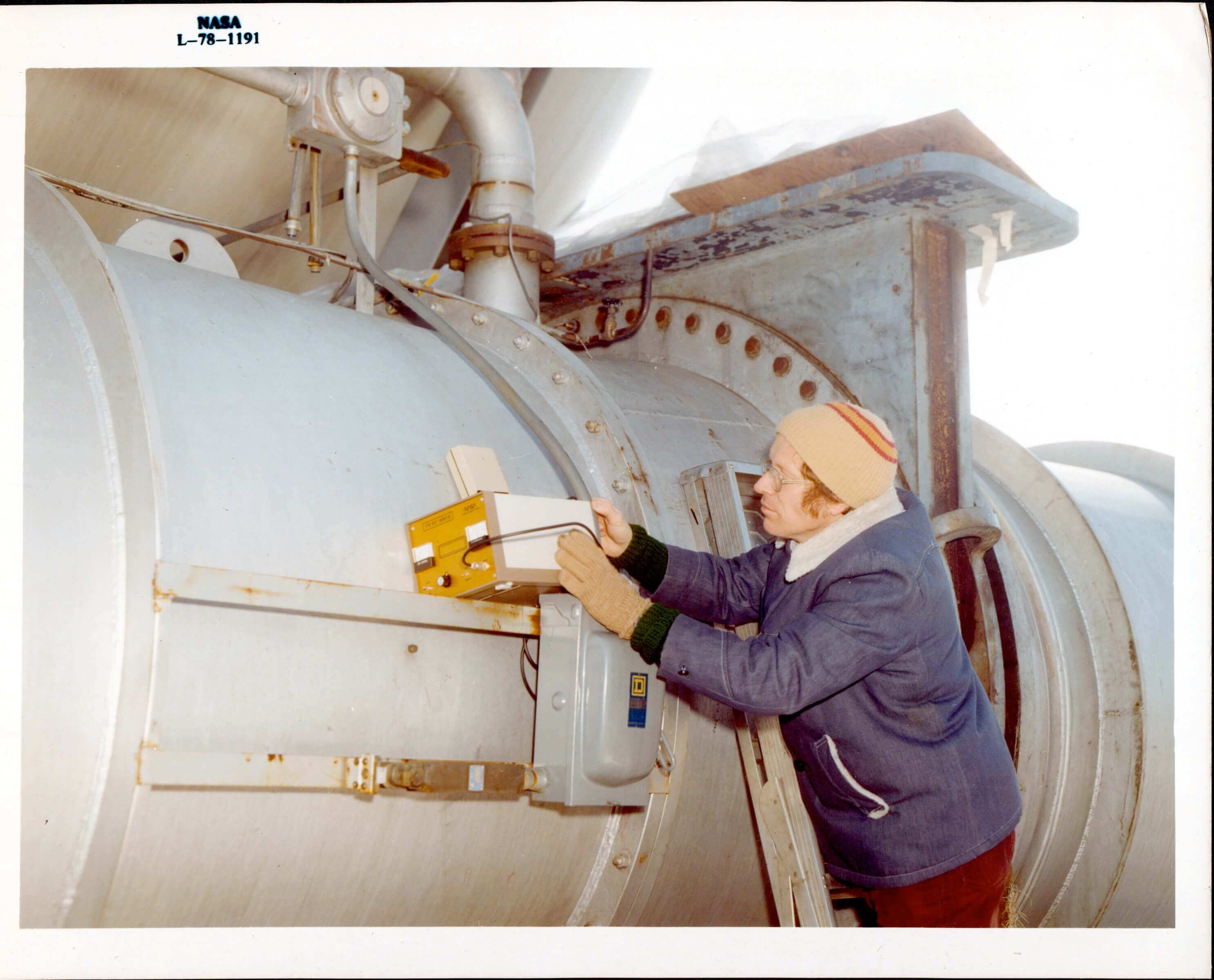 NASA engineer using an ultrasonic device to measure bolt elongation
