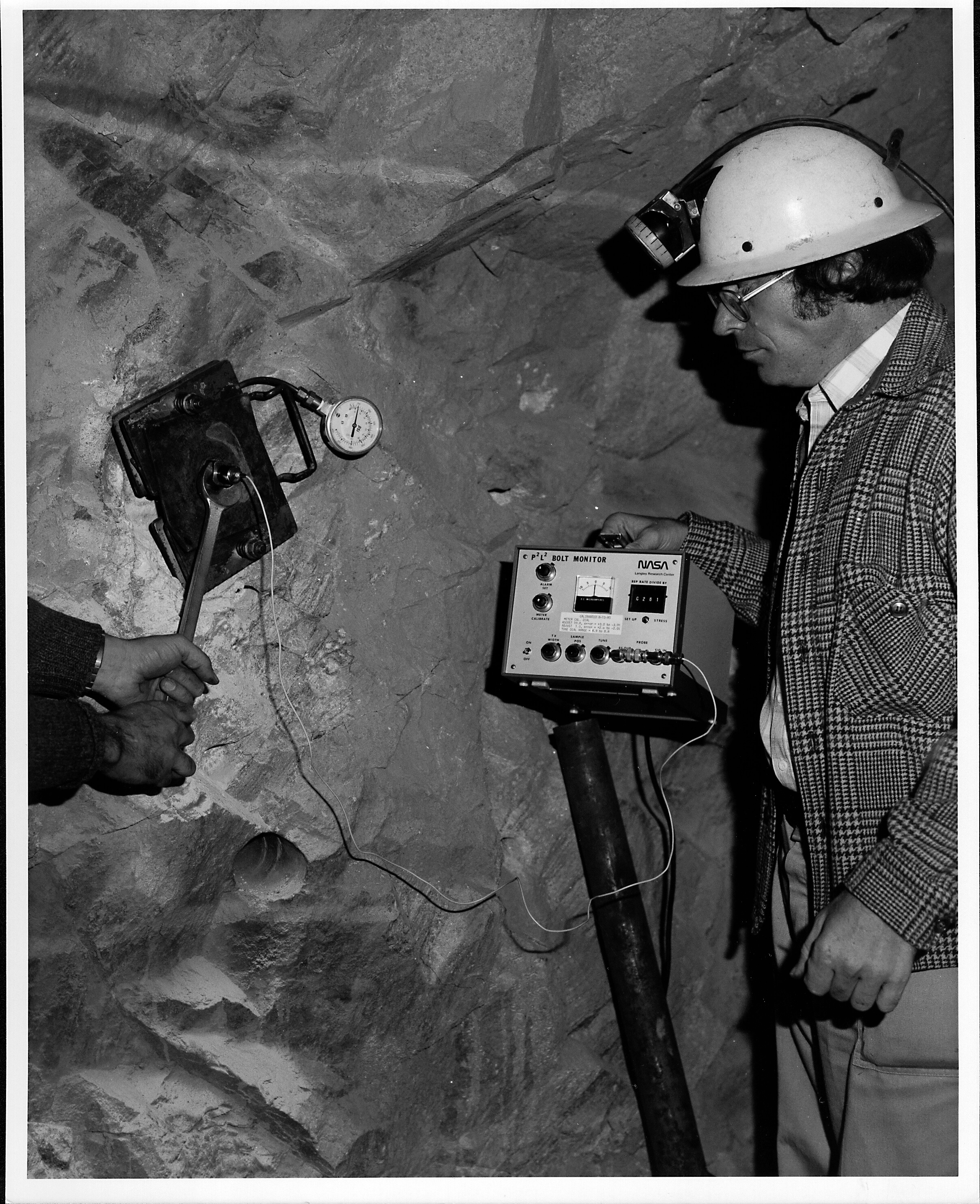 NASA engineer using an ultrasonic device to measure bolt elongation