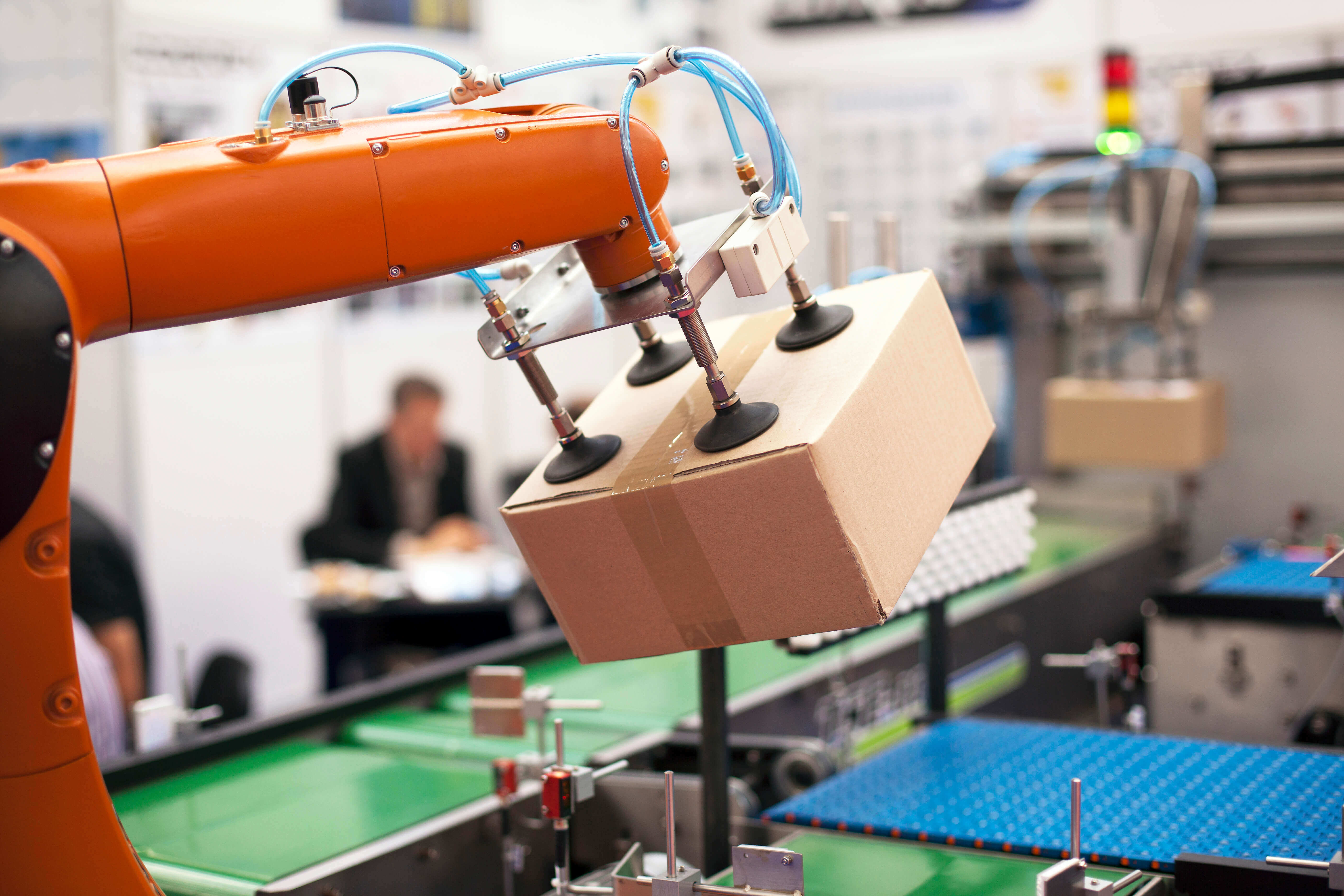 Robotic arm lifting a package