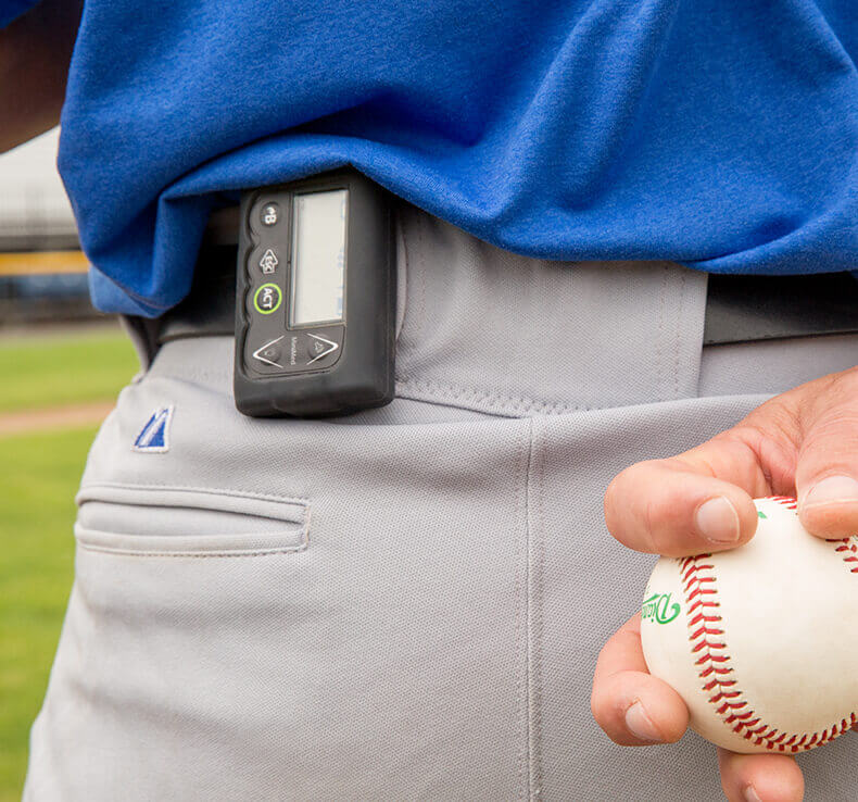Automatic insulin pump clipped to a baseball player's belt 
