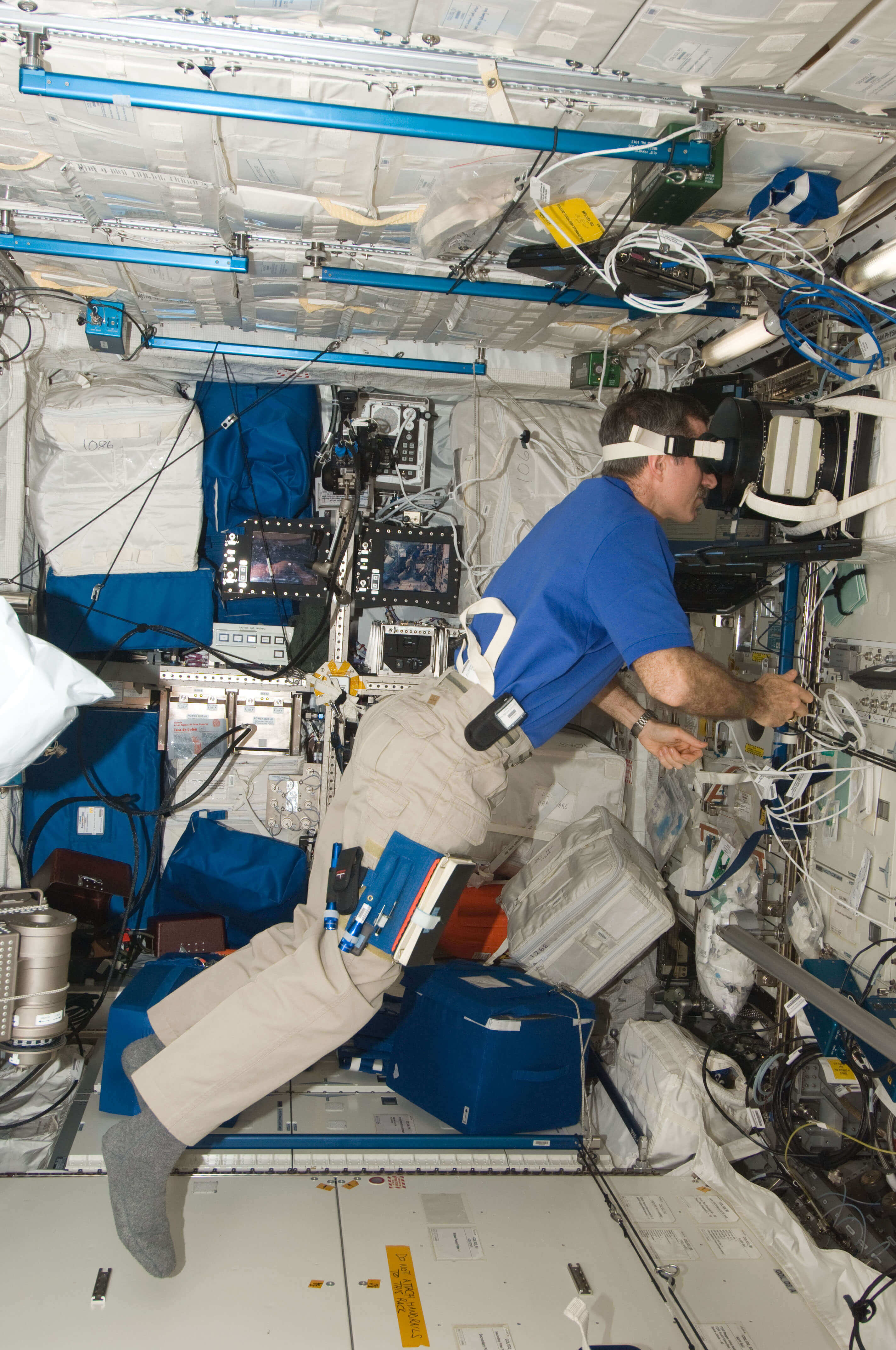 Astronaut performing an eye scan on the International Space Station 