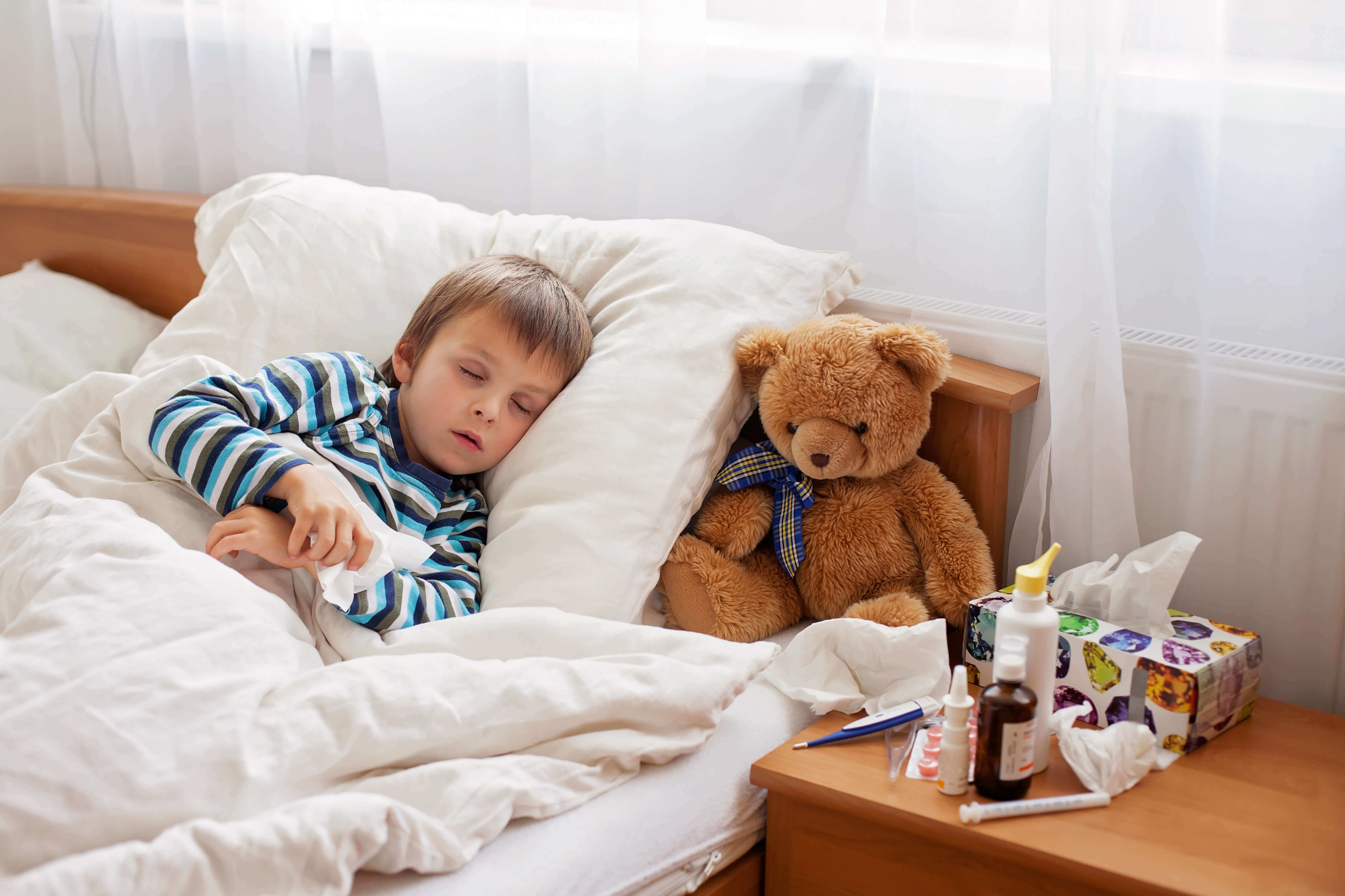Sick child resting in bed
