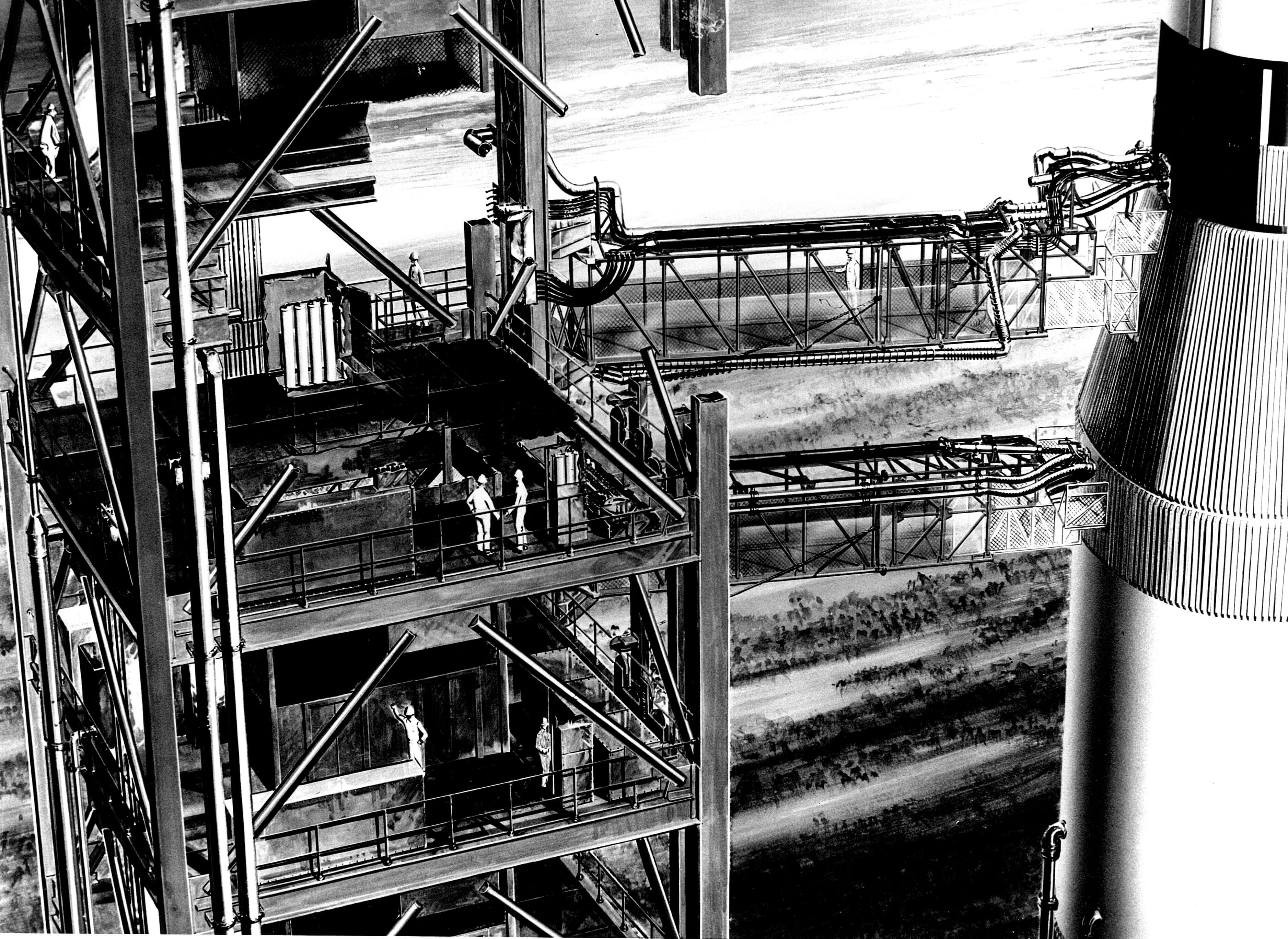 Fuel- and electricity-carrying umbilicals extend from the gantry to the Apollo spacecraft