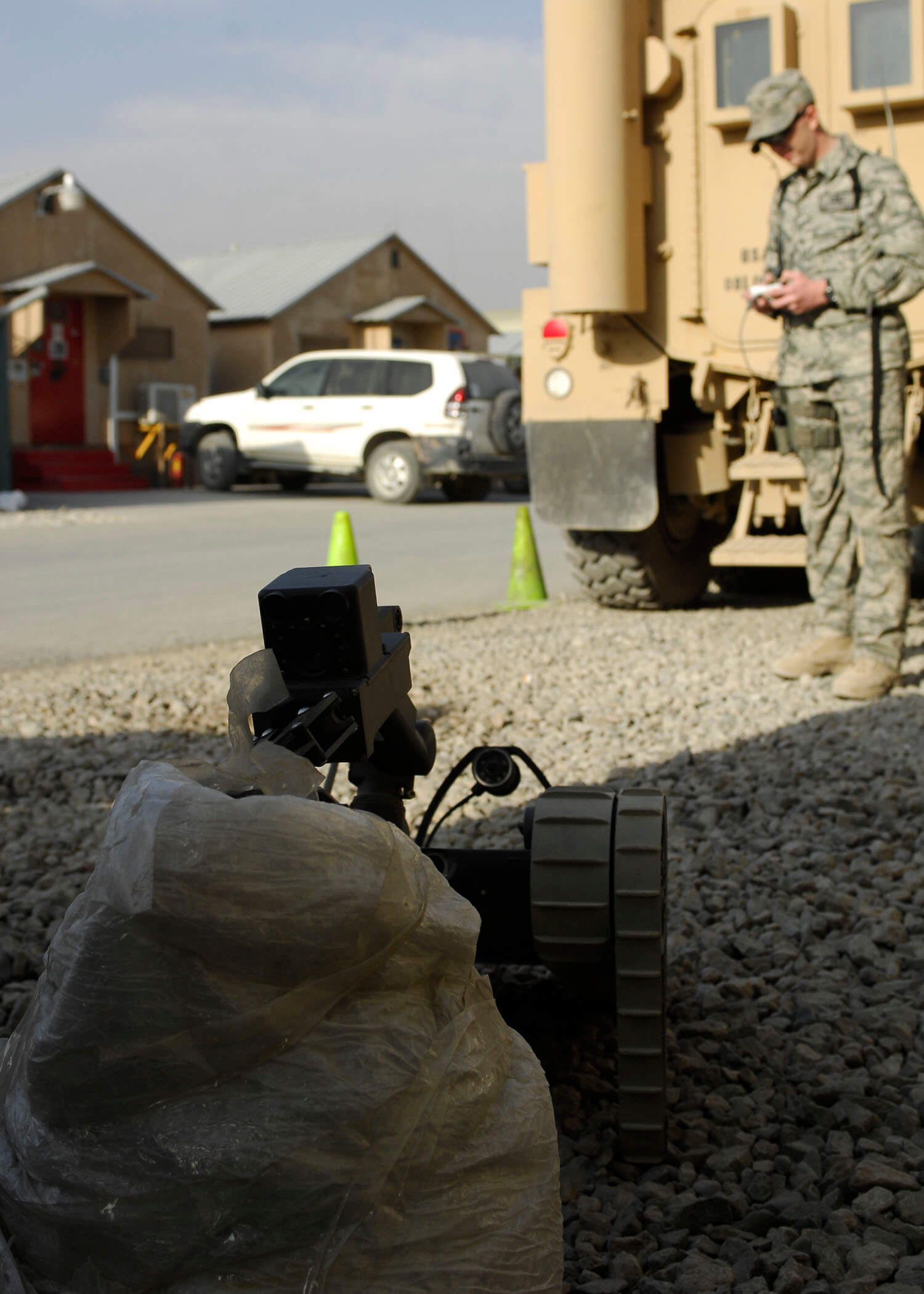 Troop practicing using a remote-controlled land mine removal device 