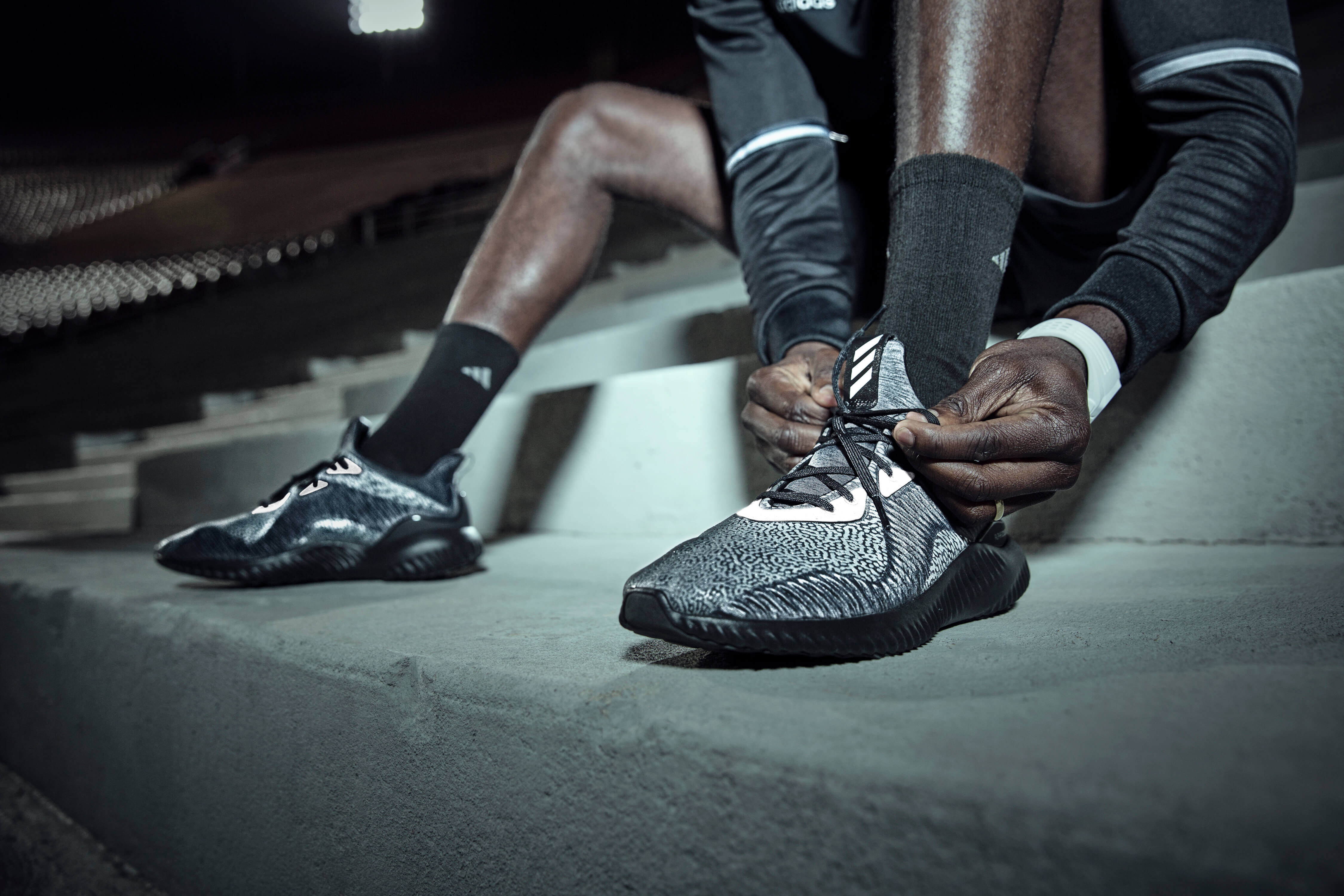 Man tying on athletic shoes 
