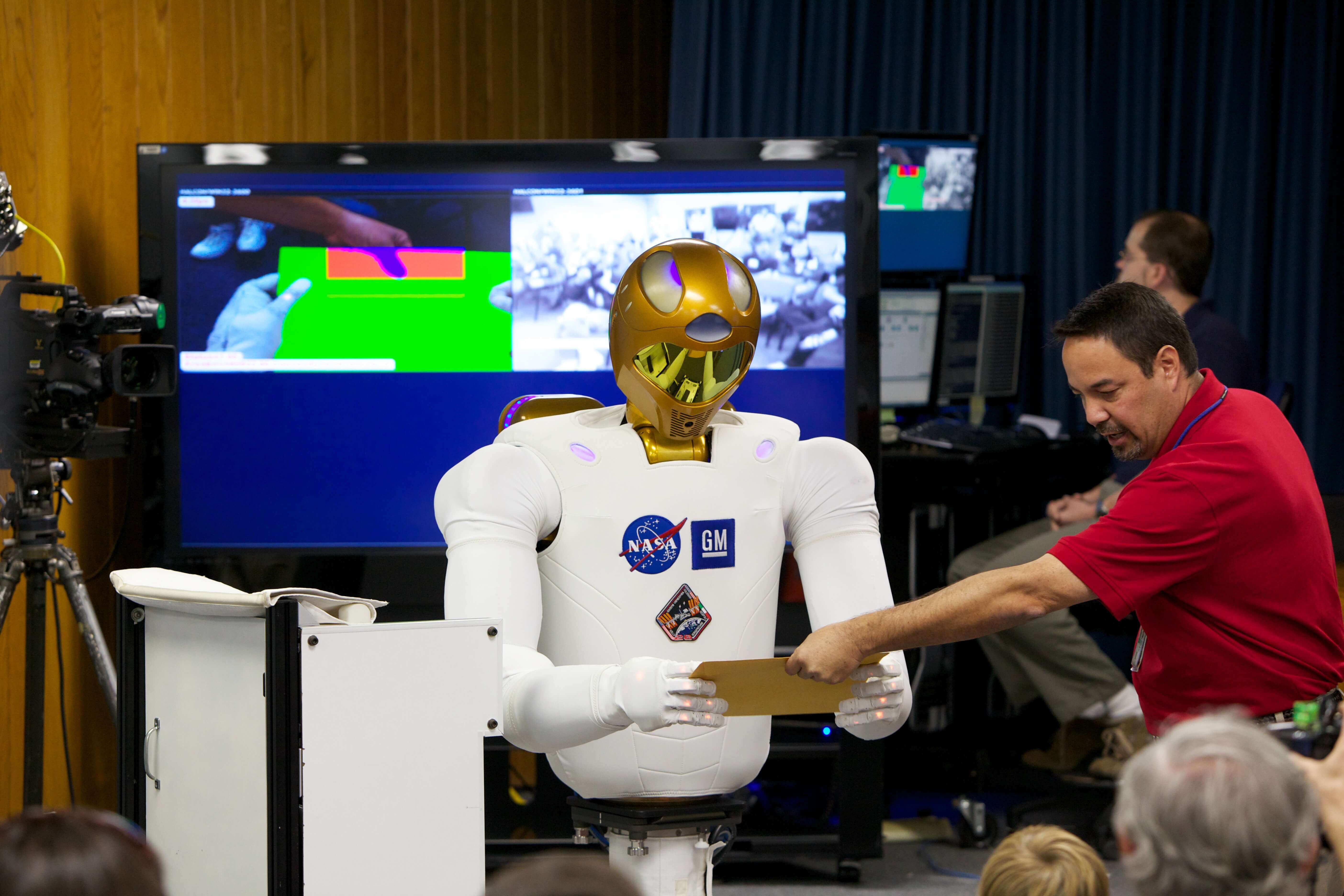 NASA's Robonaut 2 robot looking at a piece of paper 