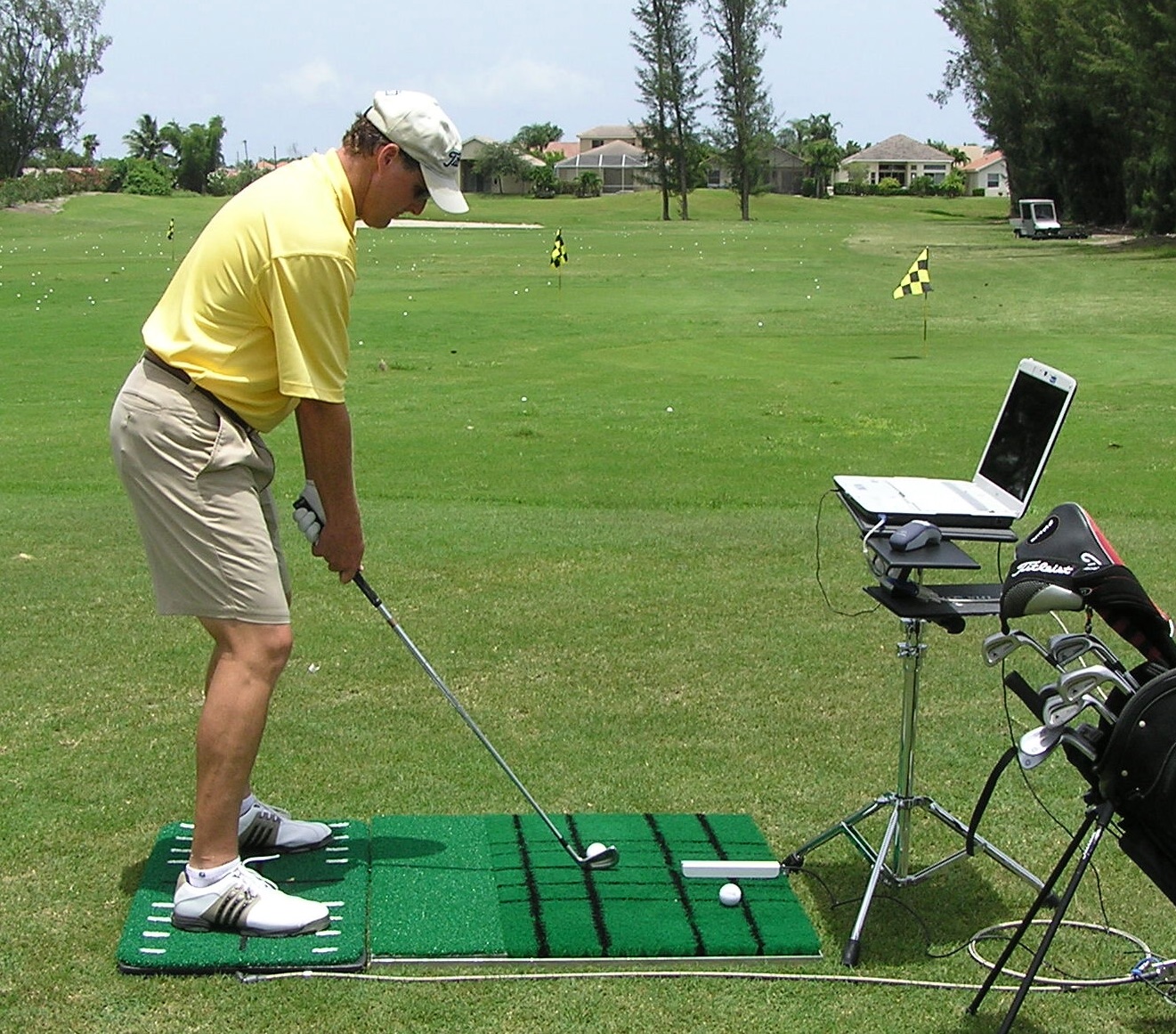 Golf player practices with balance device 