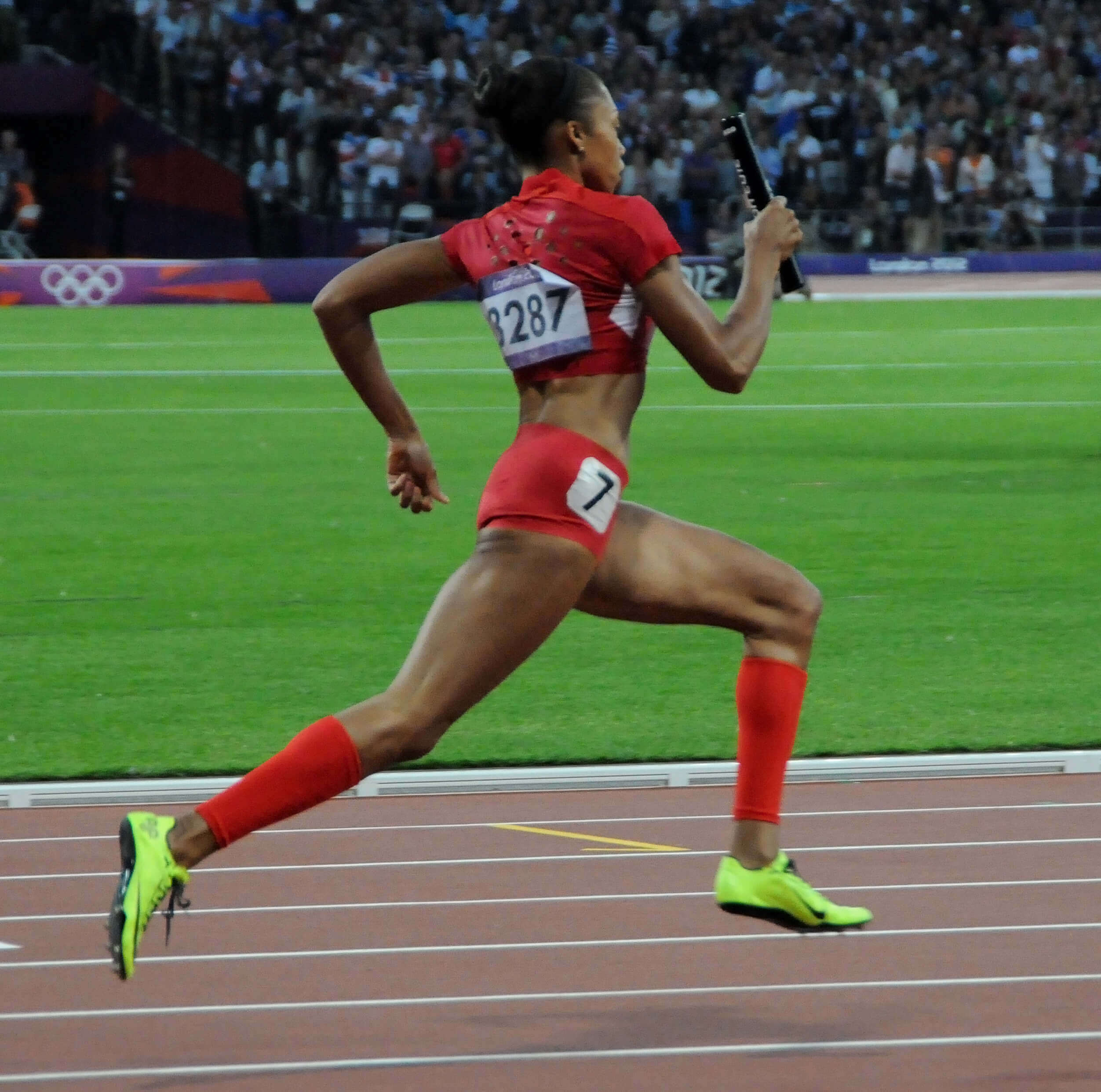 Olympic runner shown mid-race