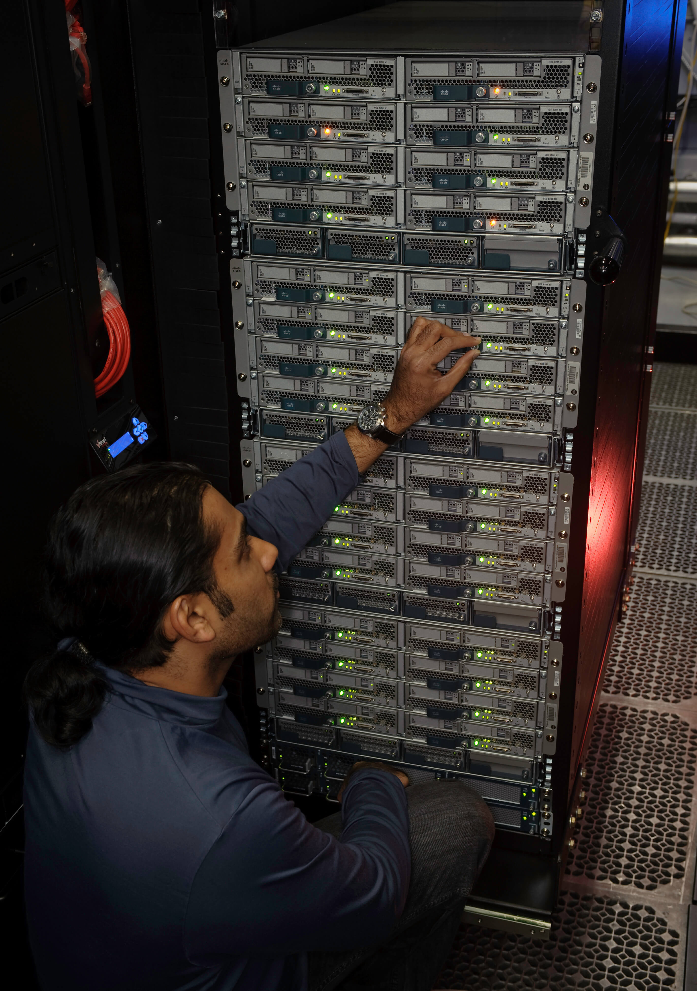 Engineer making adjustments to the servers hosting the OpenStack cloud computing platform