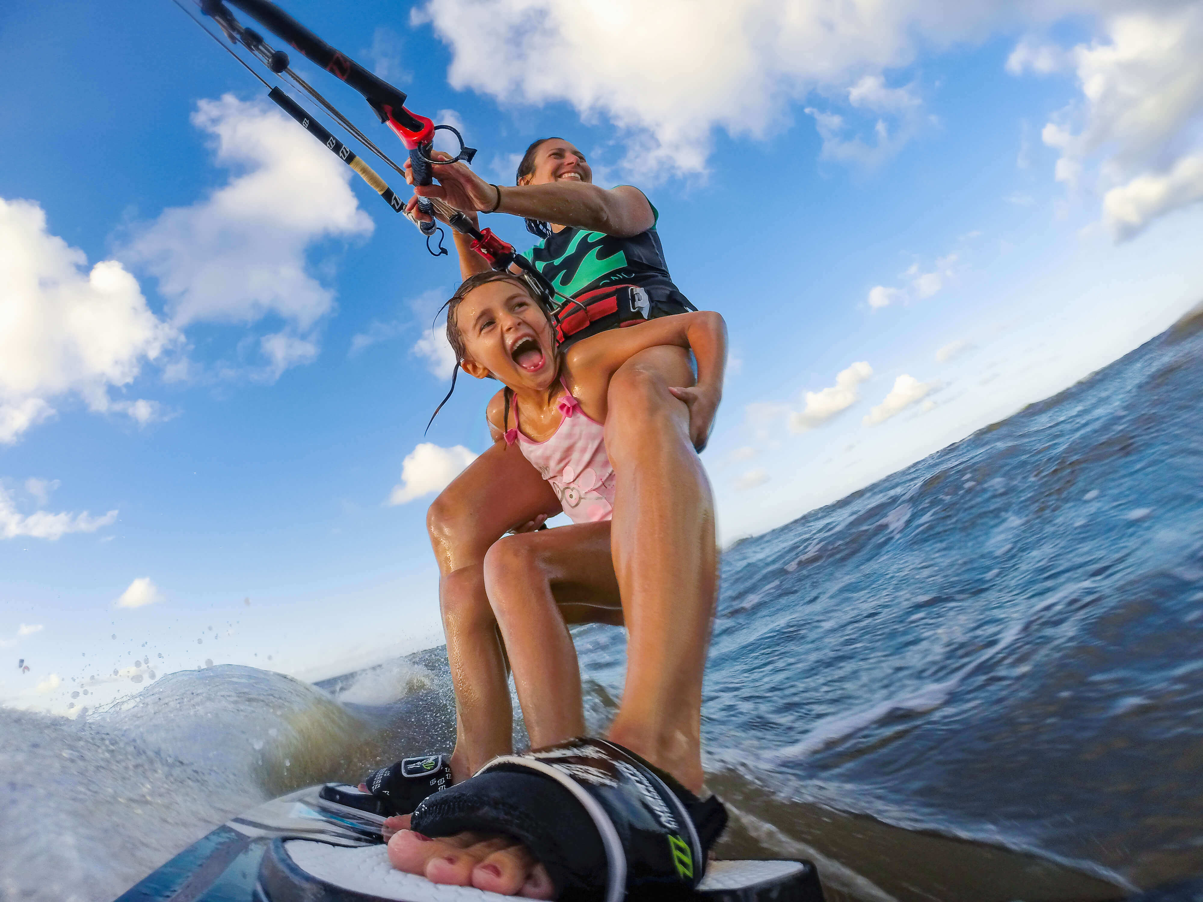 Mother and daughter filming themselves while surfing