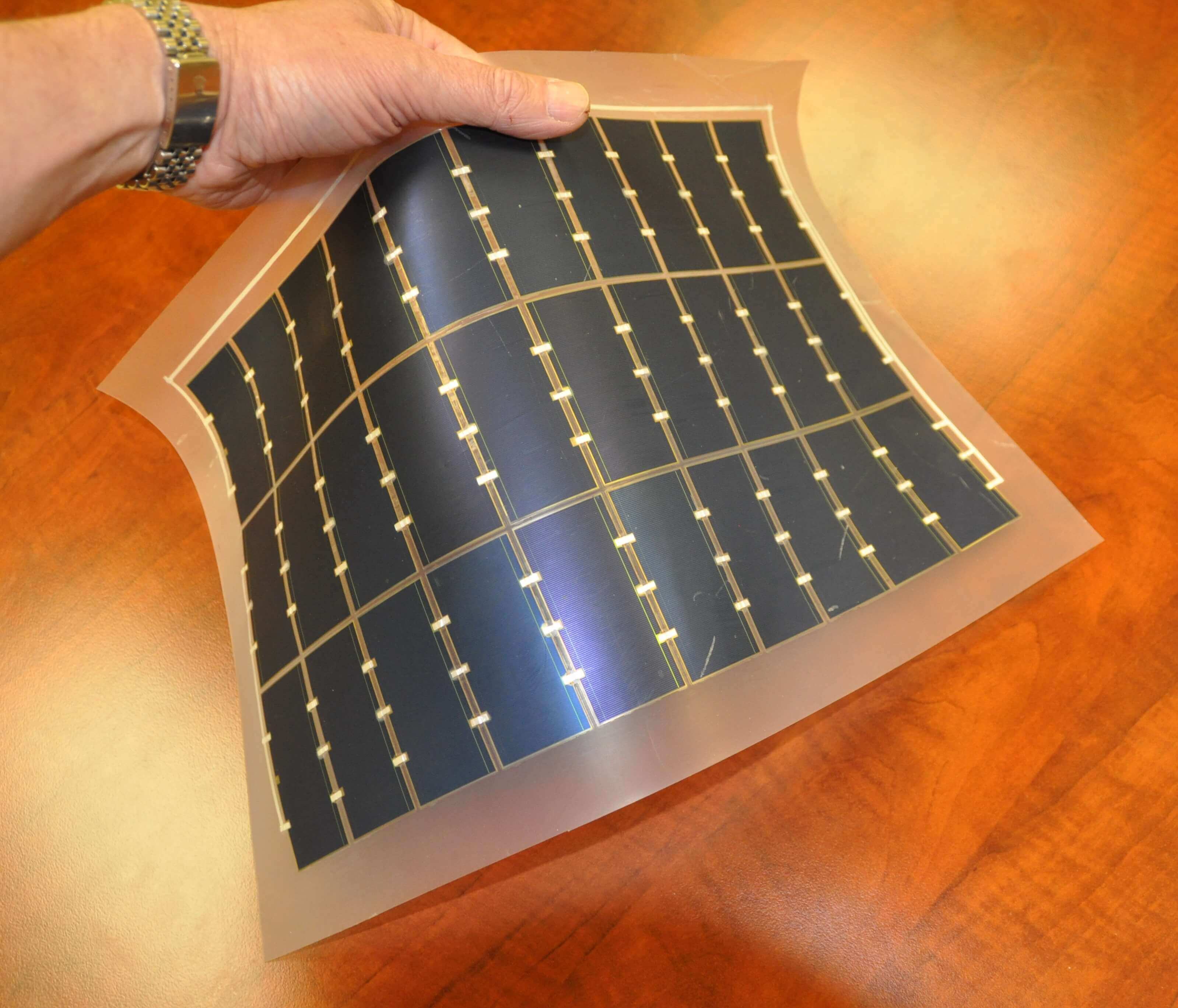 Hand manipulating a flexible solar cell 