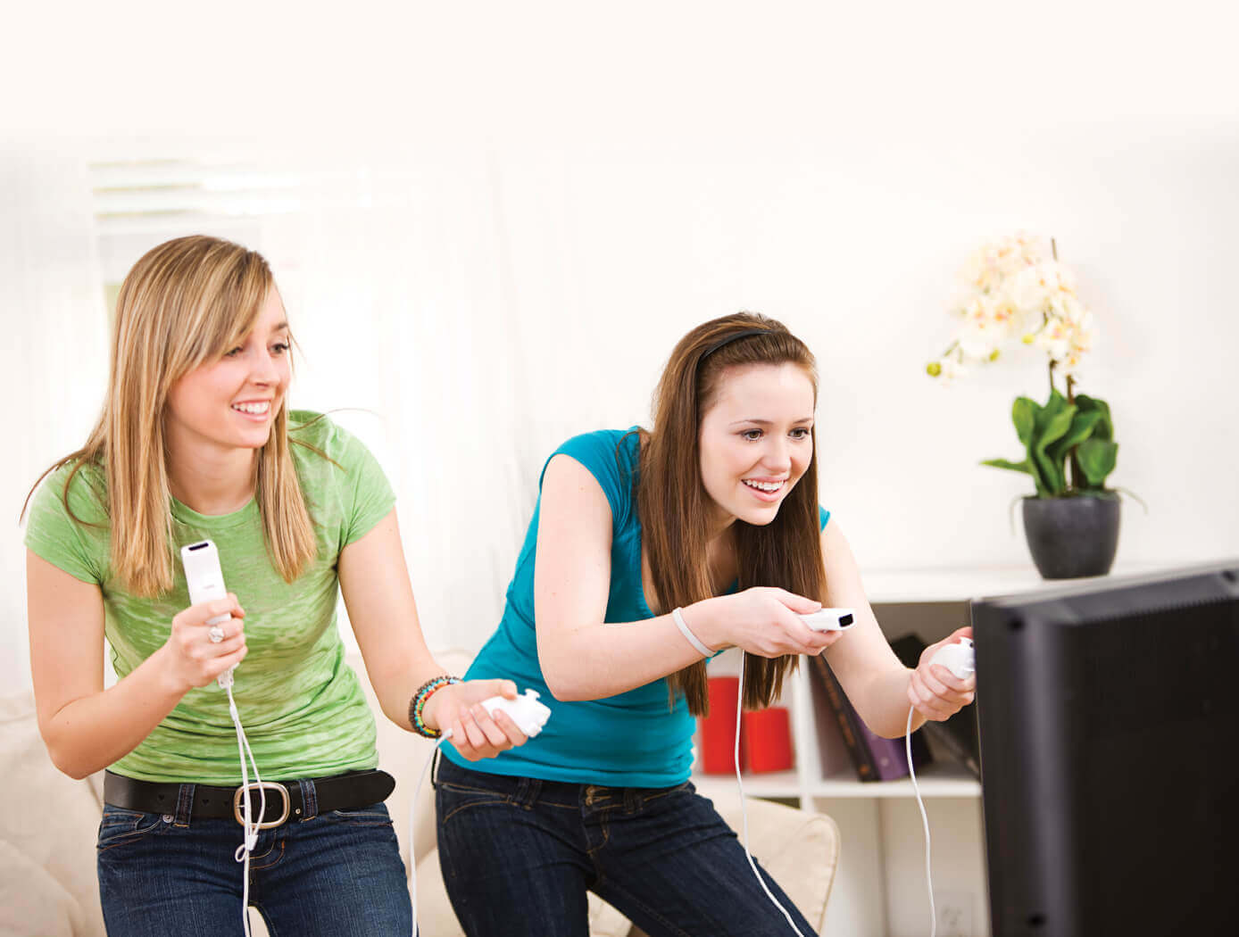 An image of two women playing a video game.