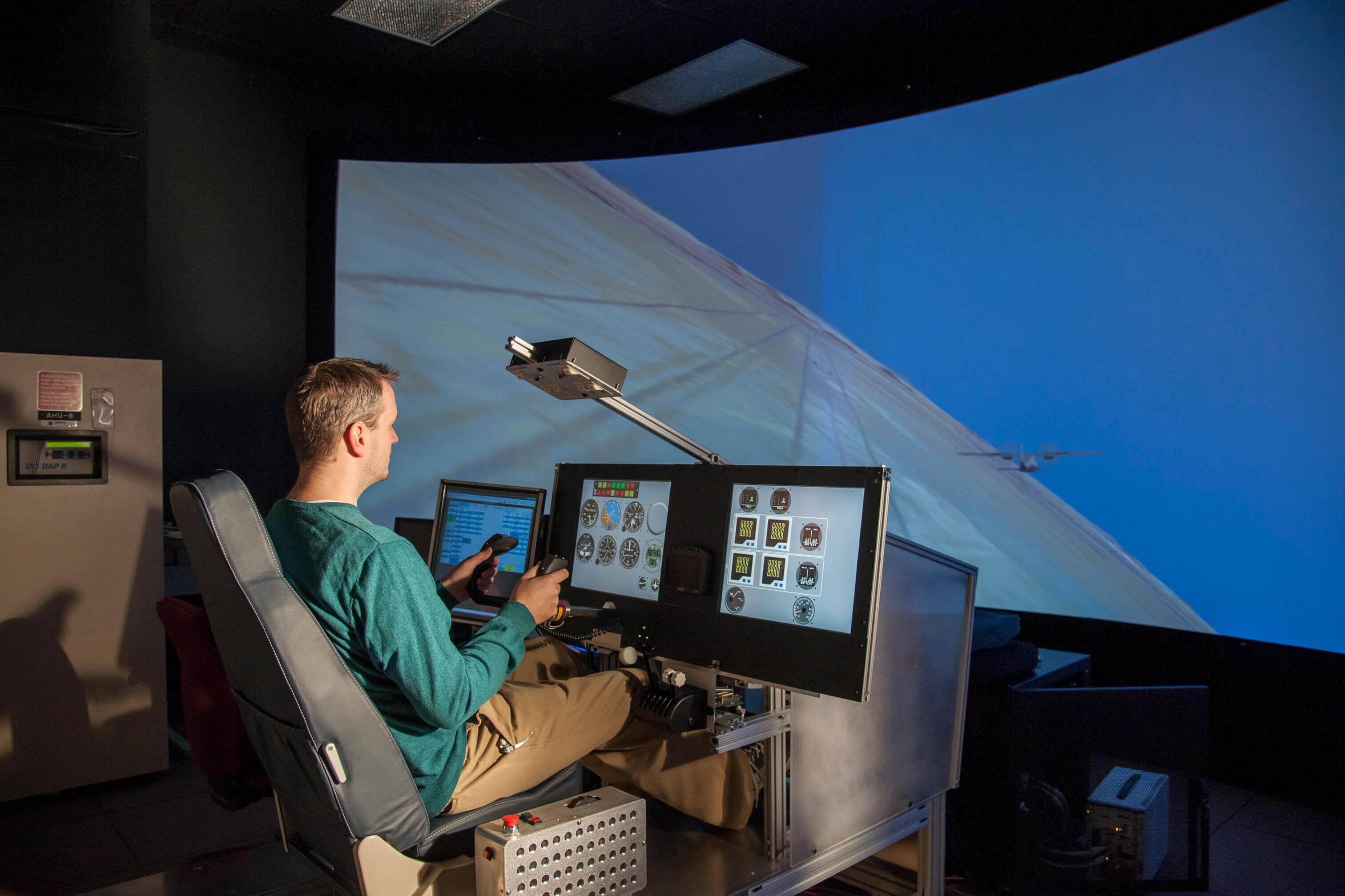 A person uses a simulator training system as part of a pilot stress test.