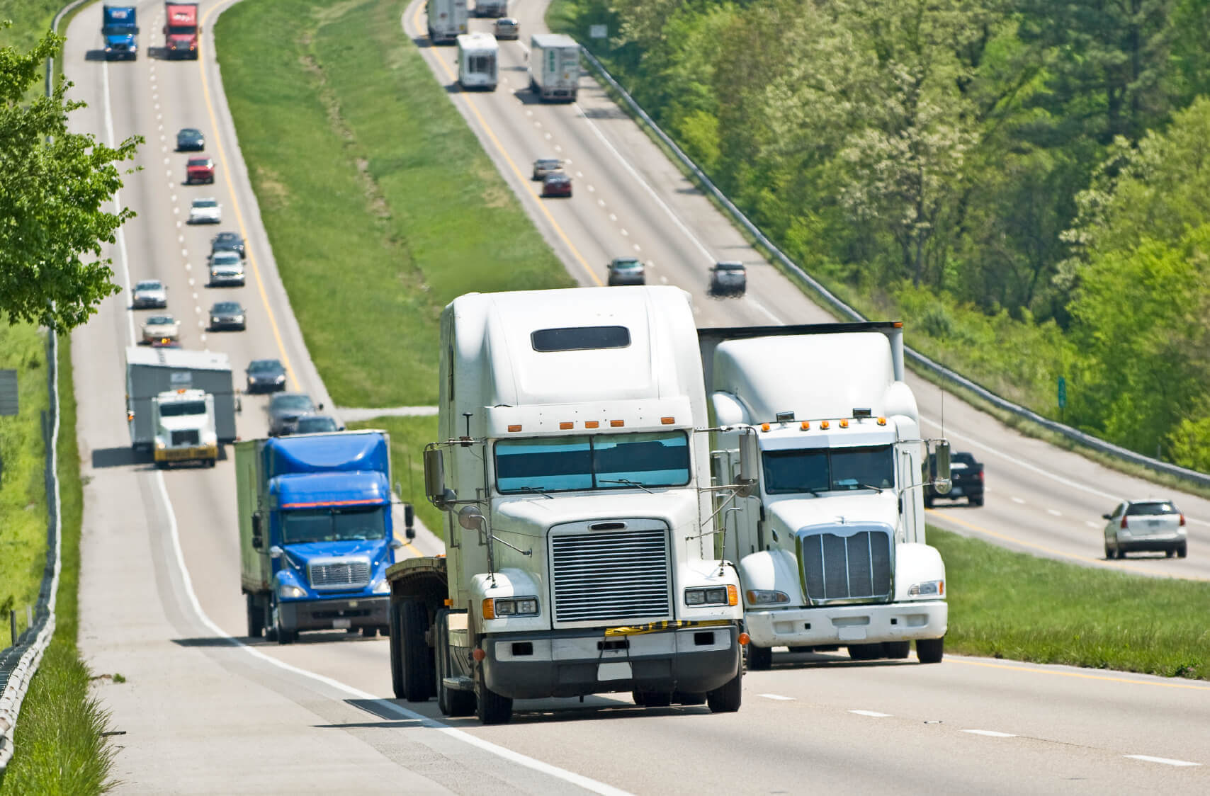 Multiple trucks driving up a hill