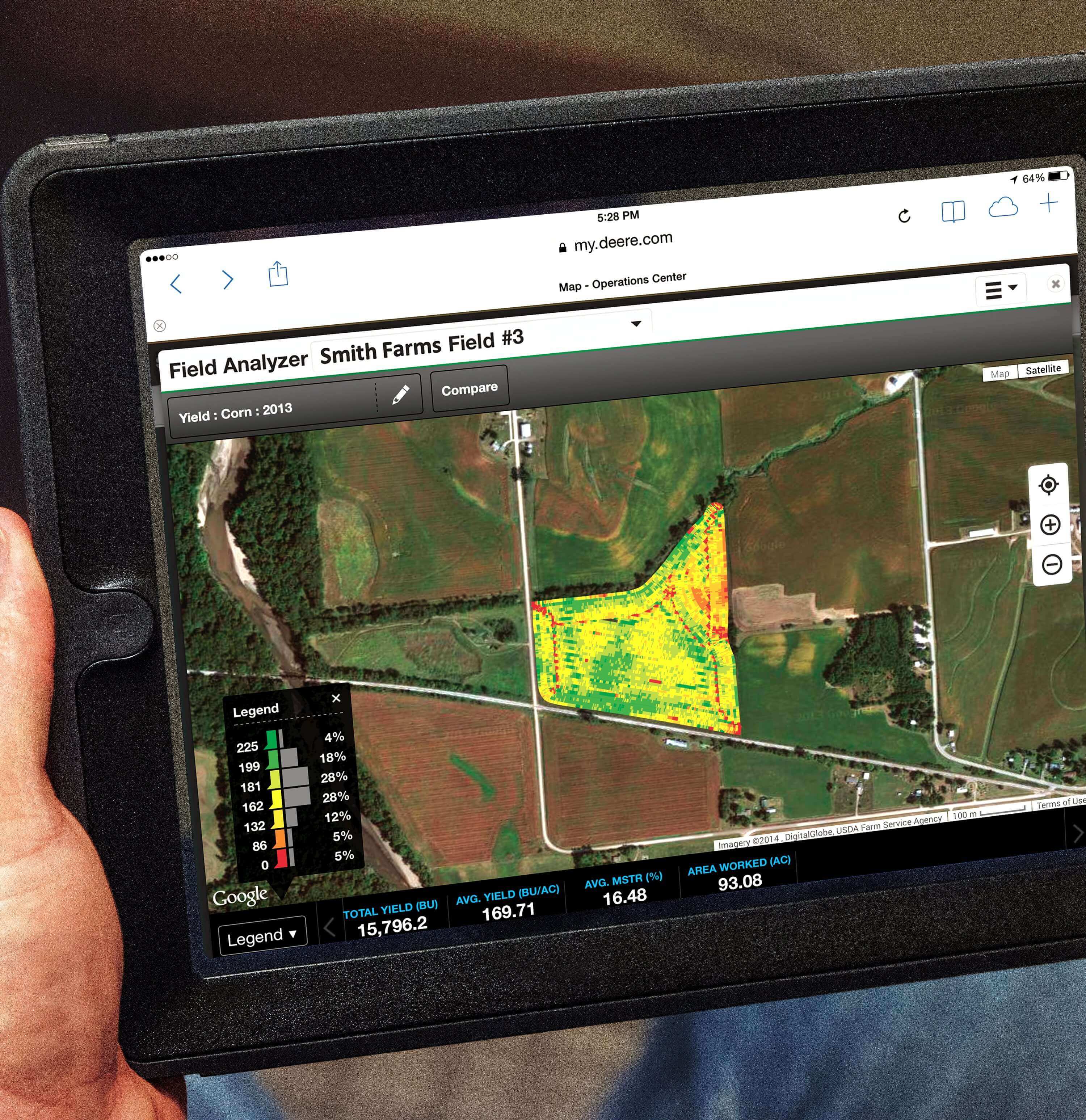 Man holding a tablet with software showing the status of his fields