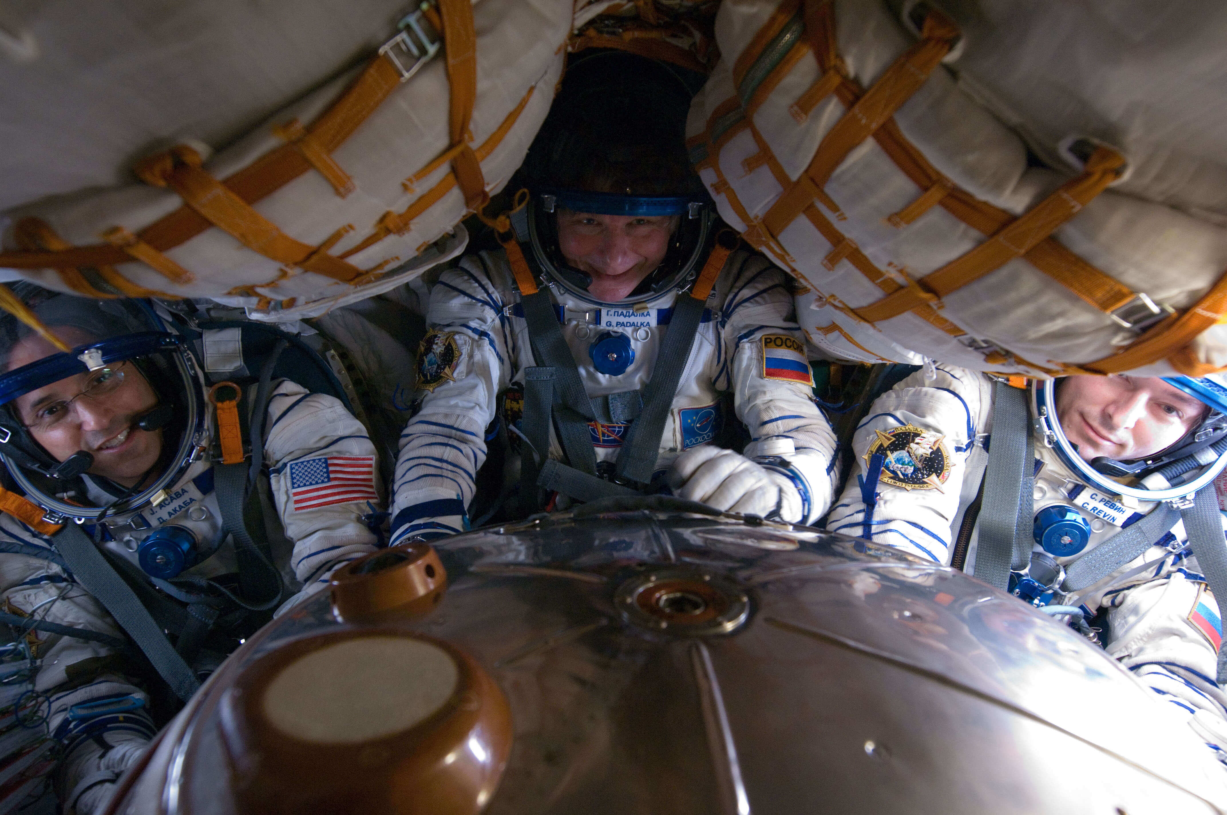 Astronauts wearing G-suits aboard the Soyuz spacecraft 
