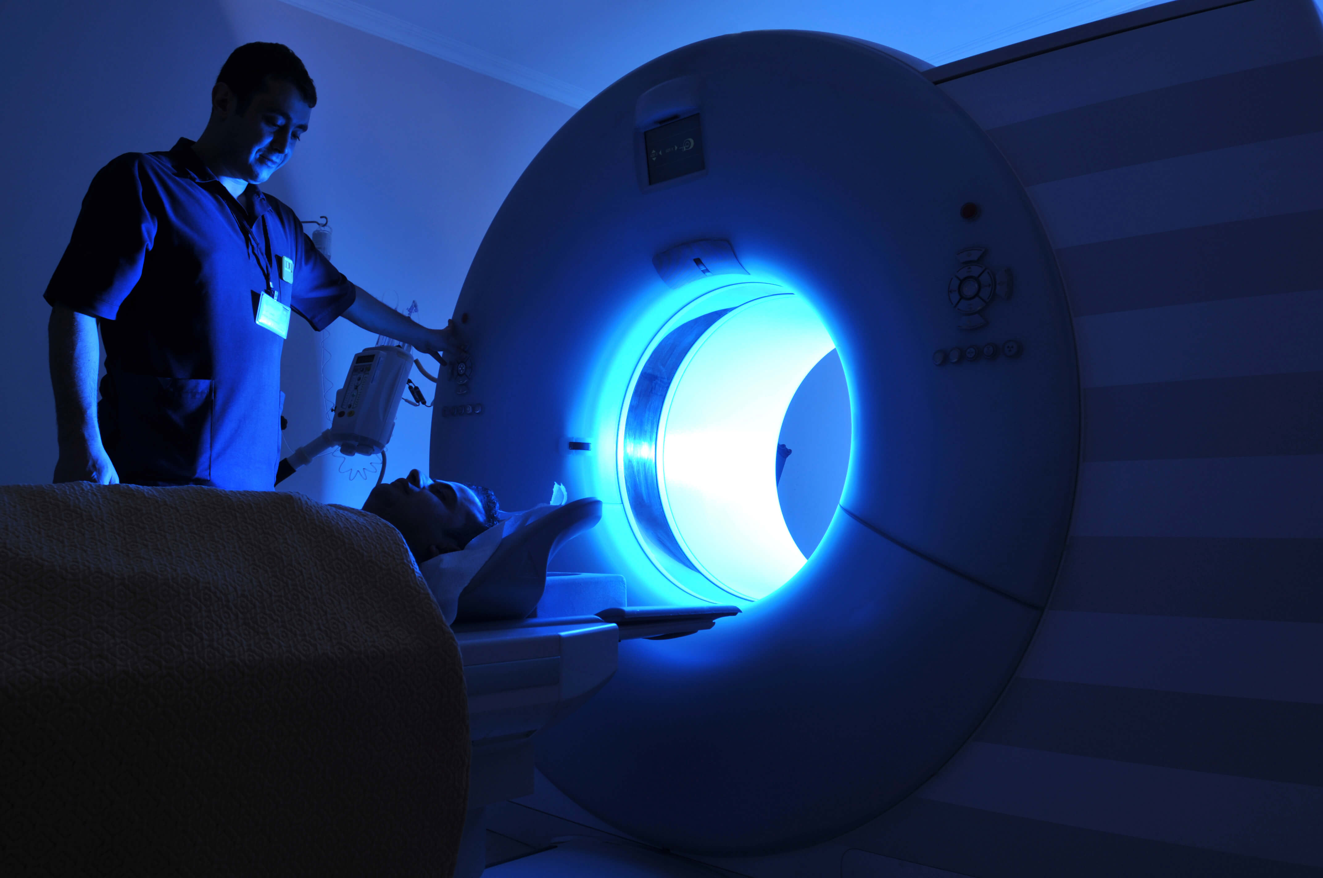 A technician putting a patient in an MRI machine 