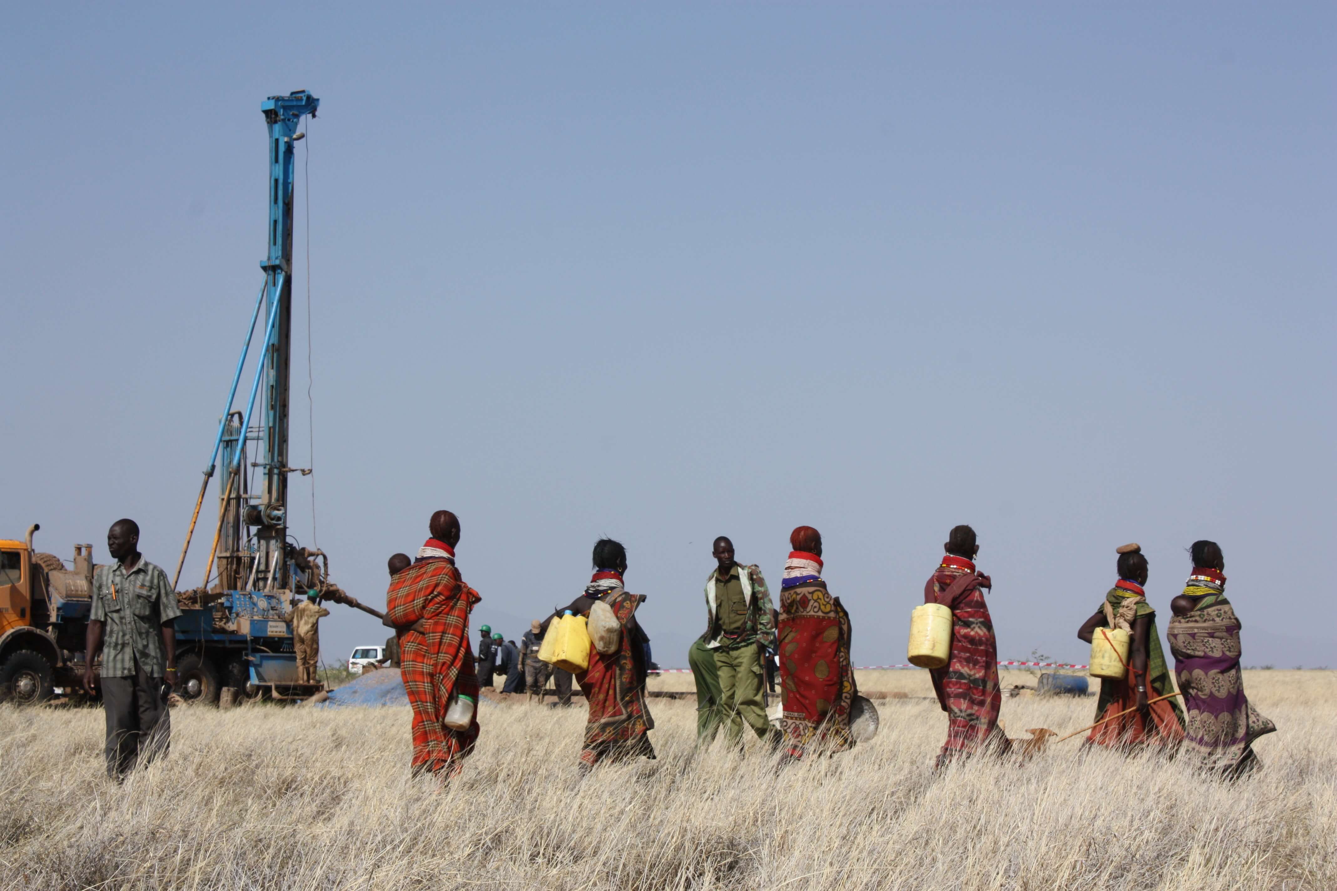 Turkana women coming with containers to gather newly discovered water from a drilled well in the Lotikipi basin