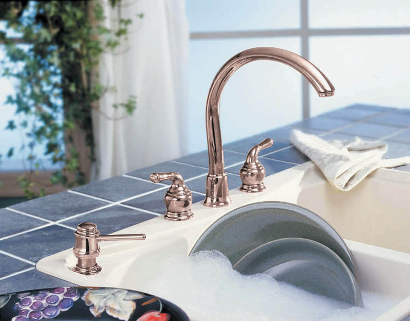 Kitchen sink fixture with a polished brass finish