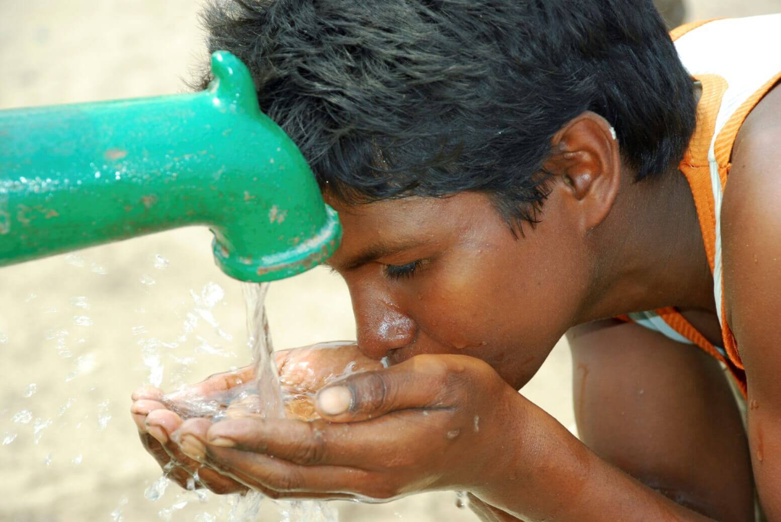 Child drinking clean water from a well