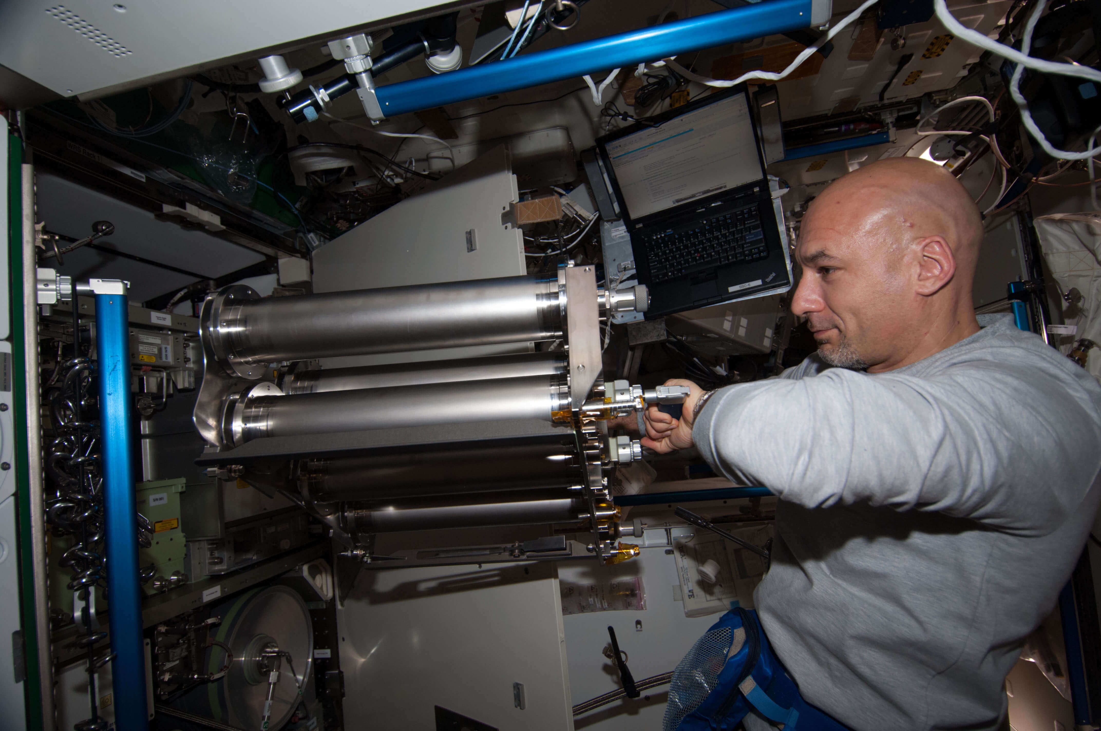 Astronaut working with a water filtration system aboard the International Space Station