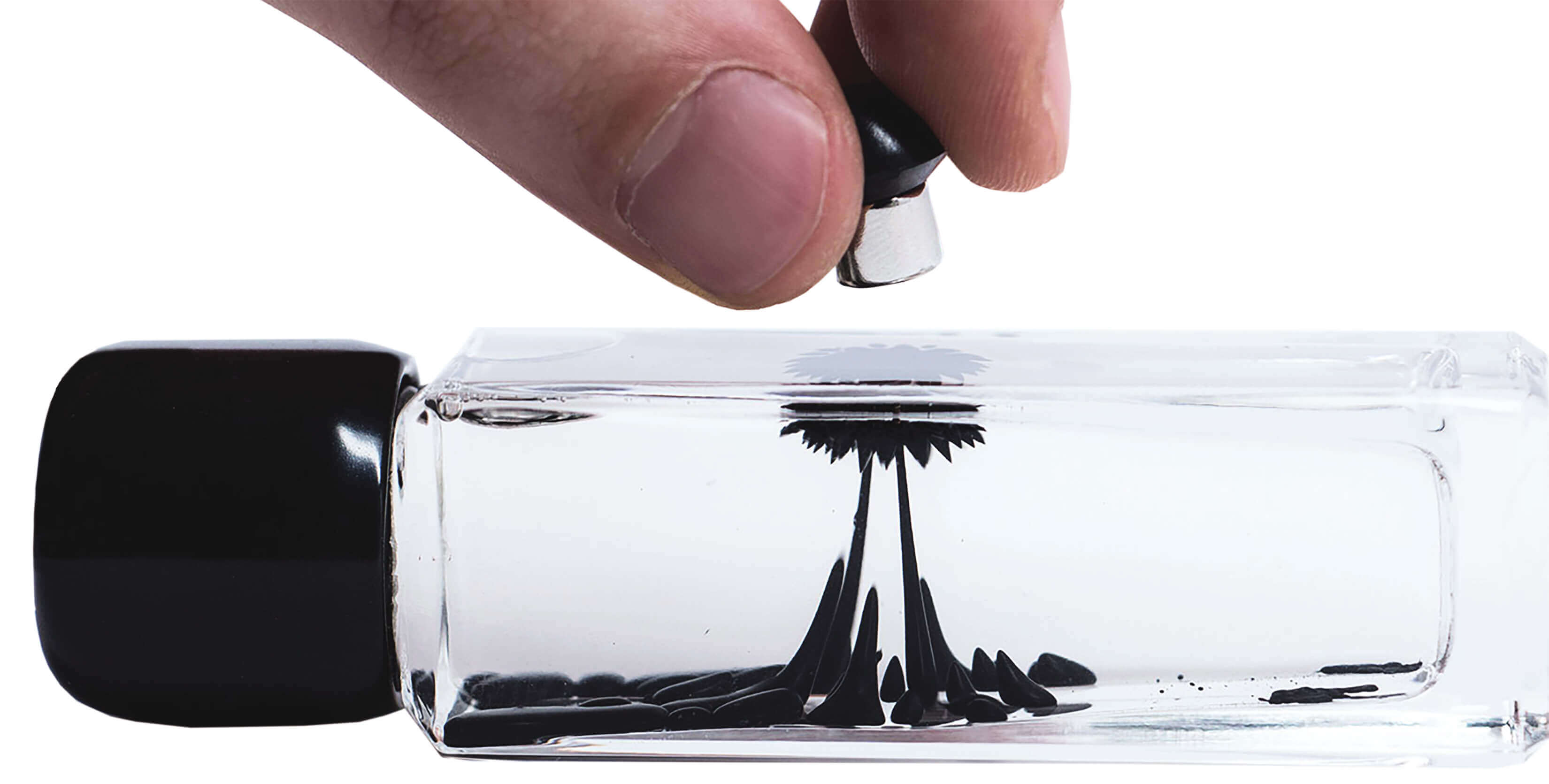 Ferrofluid in a container being manipulated by a magnet