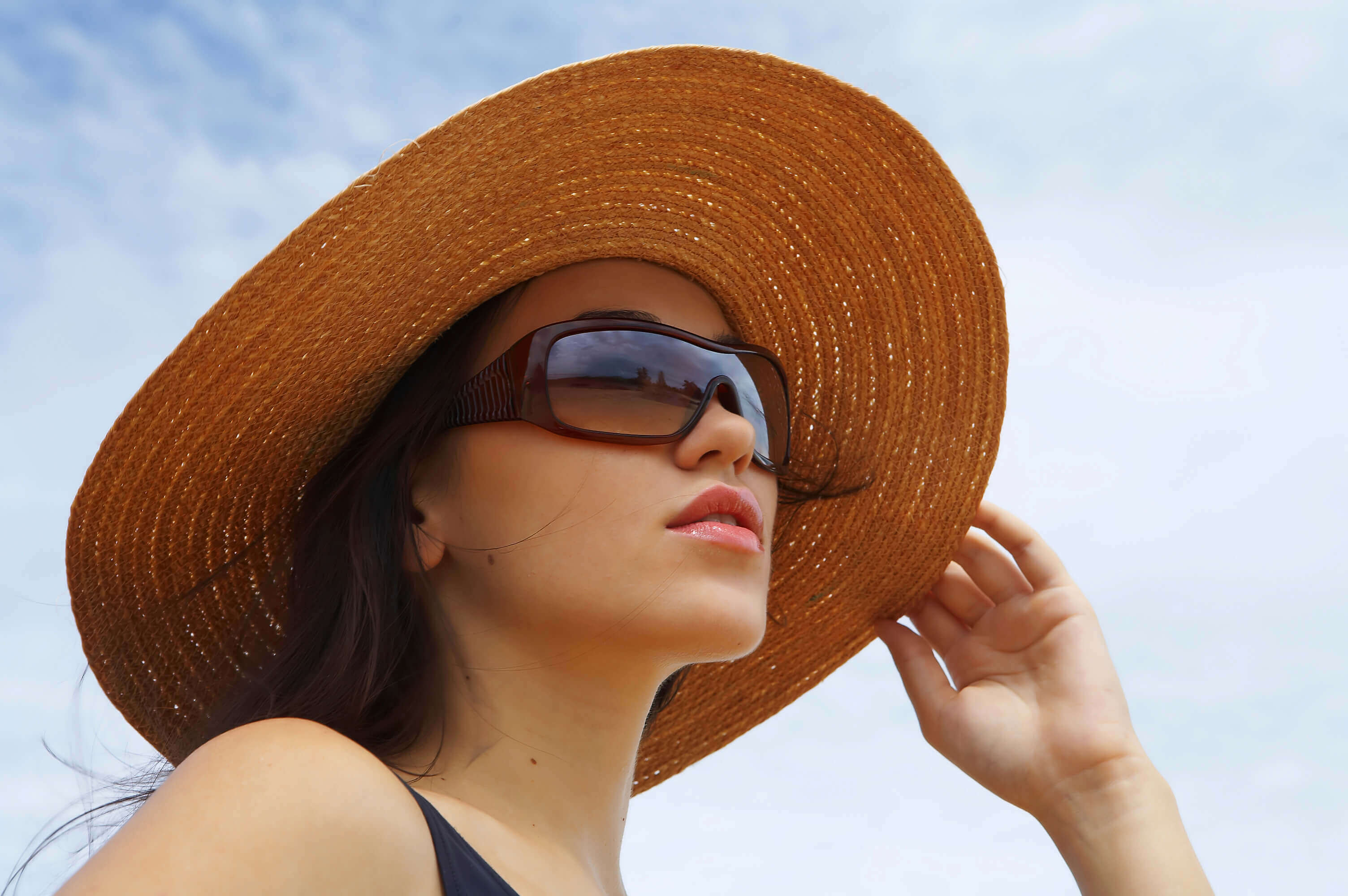 Woman wearing sunglasses and a hat