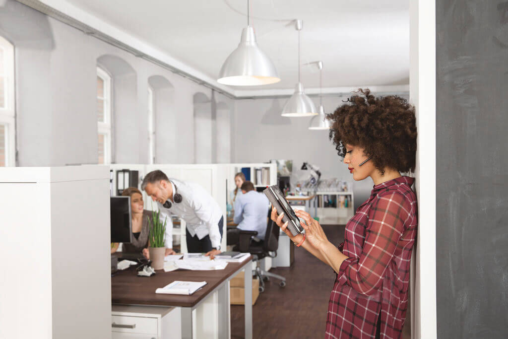Office worker using a wireless headset for communication