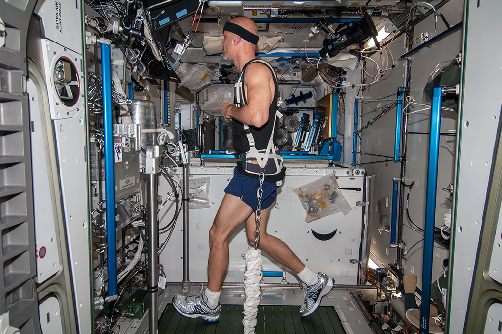 Astronaut exercising on a treadmill on the International Space Station 
