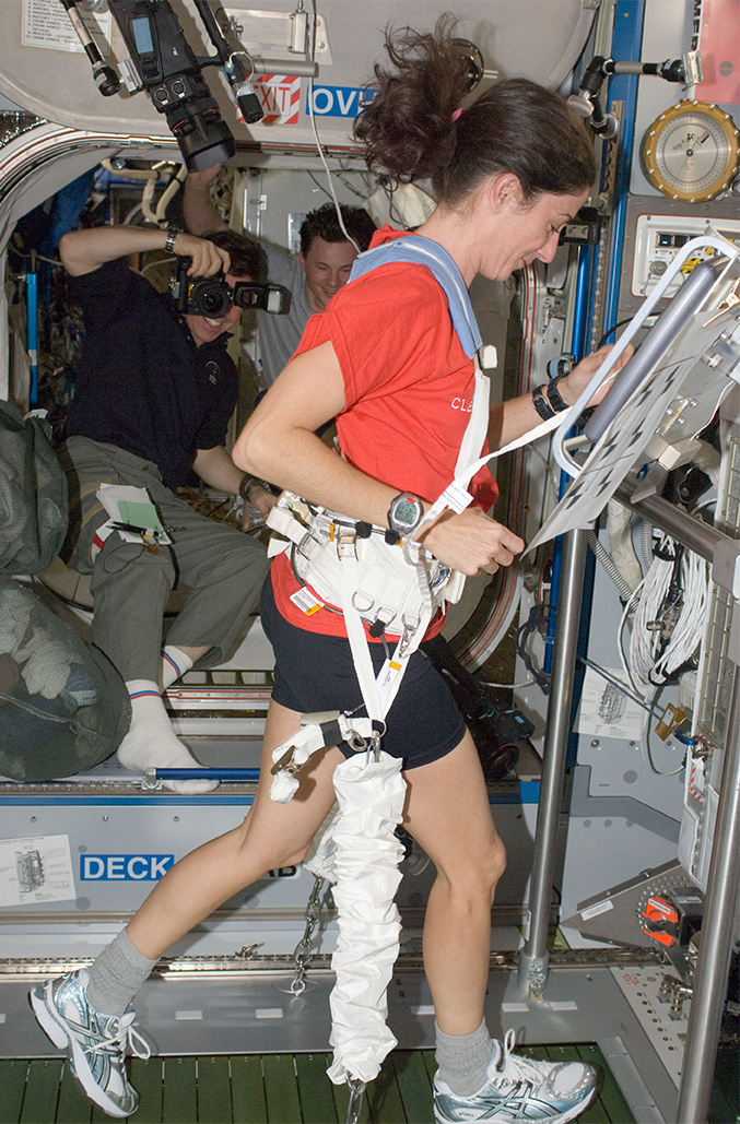 Astronaut exercising on a treadmill on the International Space Station 